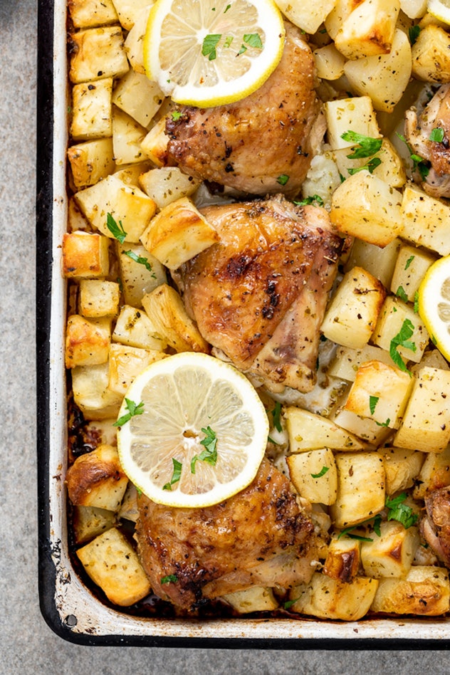image of gluten-free sheet pan recipe featuring greek baked chicken and potatoes, topped with lemon ...