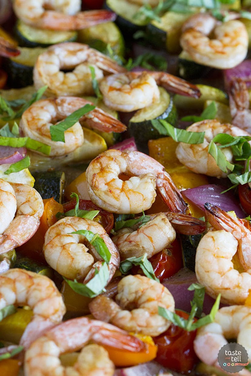 image of gluten-free sheet pan recipe featuring a closeup of shrimp with summer veggies and basil