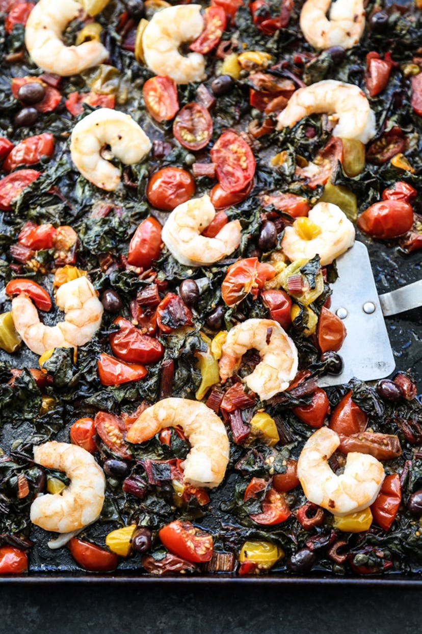 gluten-free sheet pan recipe with shrimp olives capers tomatoes and greens