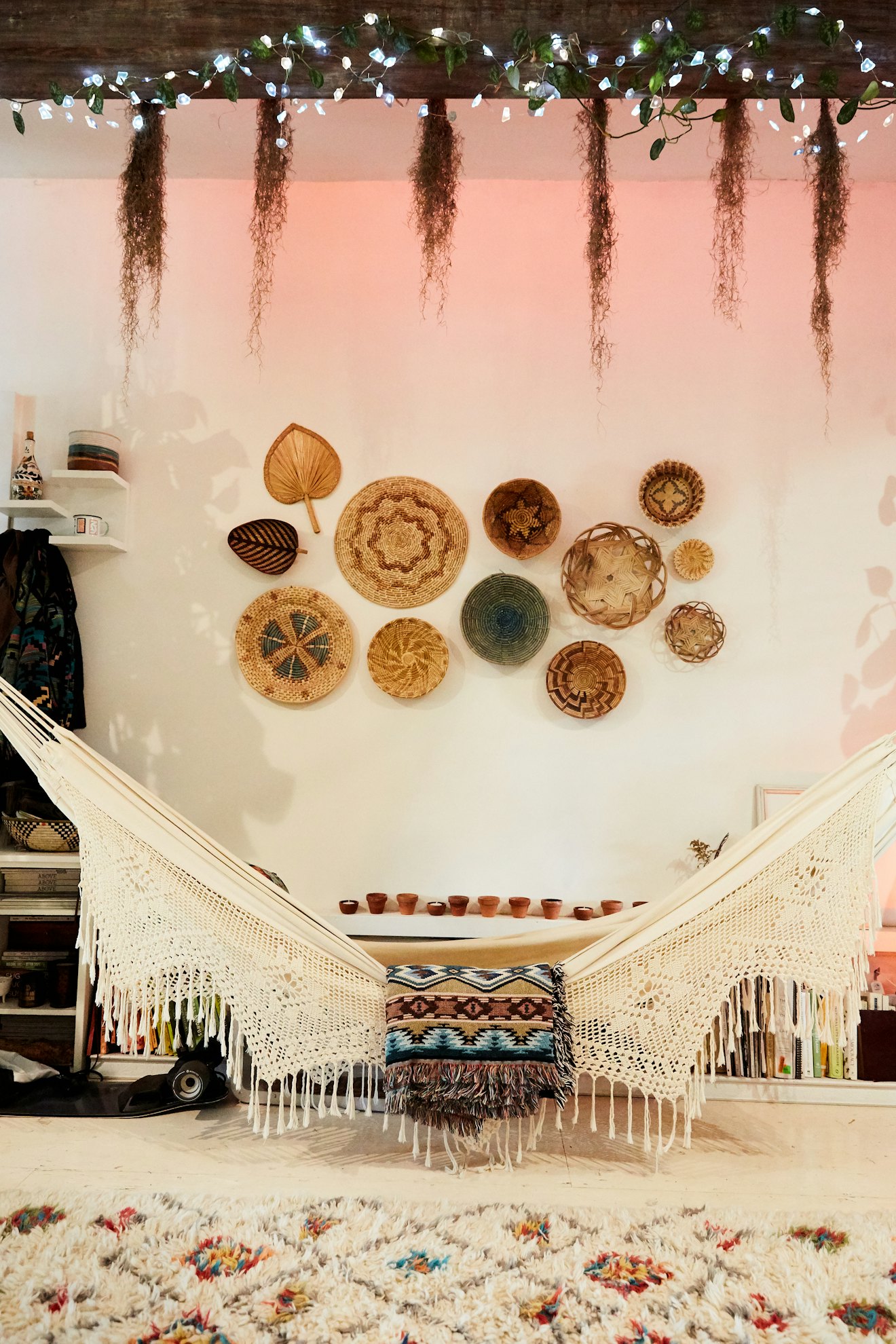 Cotton Ecru Fabric Hammock with a patterned blanket and set of wall baskets in the background