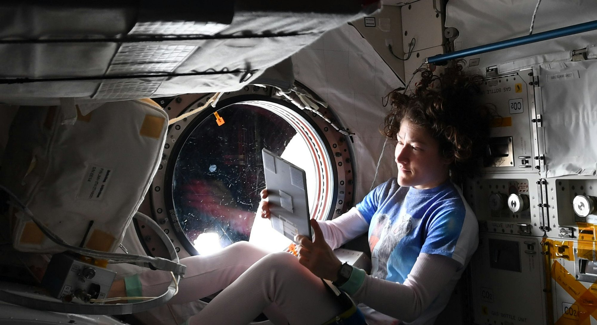 Christina Koch on a tablet in her out-of-this-world home