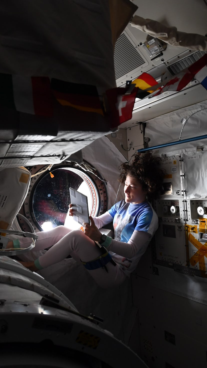 Christina Koch on a tablet in her out-of-this-world home
