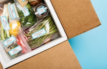 An open-carton meal subscription box with veggies in it