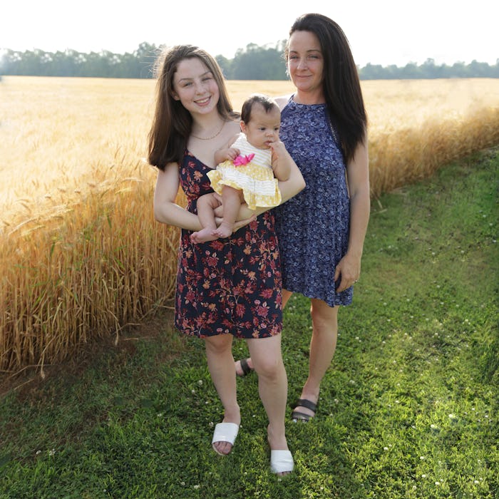 Tyra & Tiarra From ‘Unexpected; holding their baby next to a field of wheat