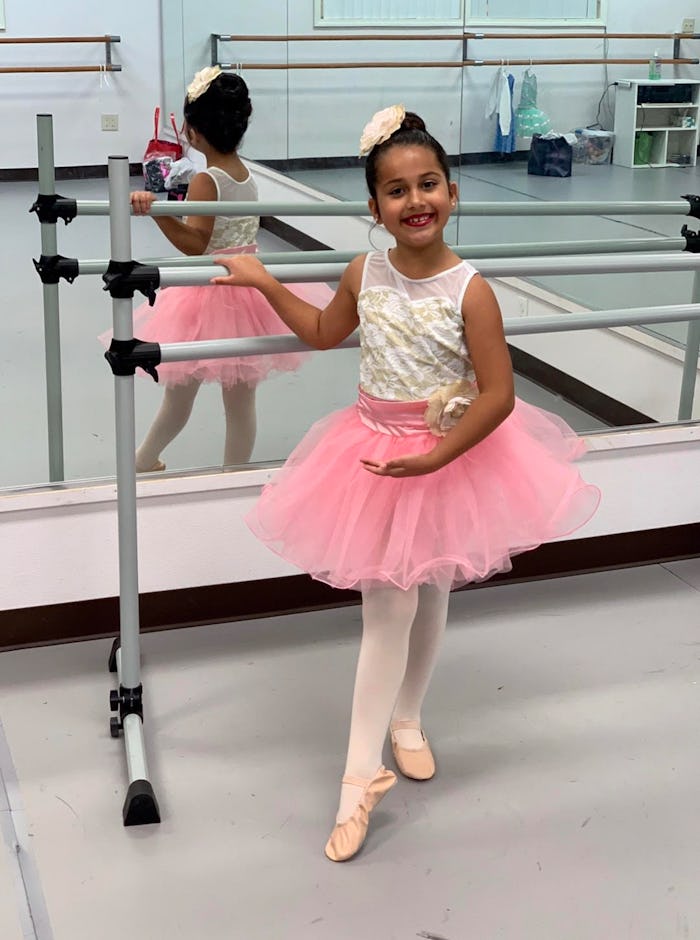 A little girl in a ballet outfit