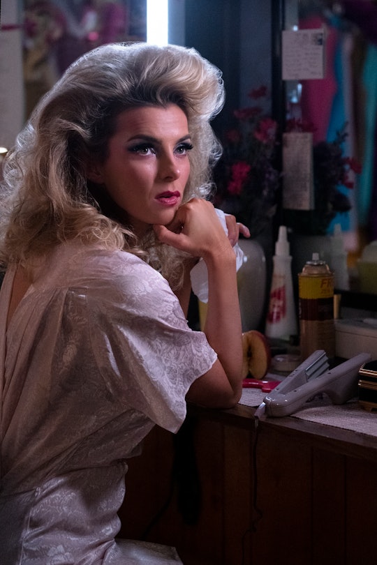 Betty Gilpin in Glow in a white dress at a vanity