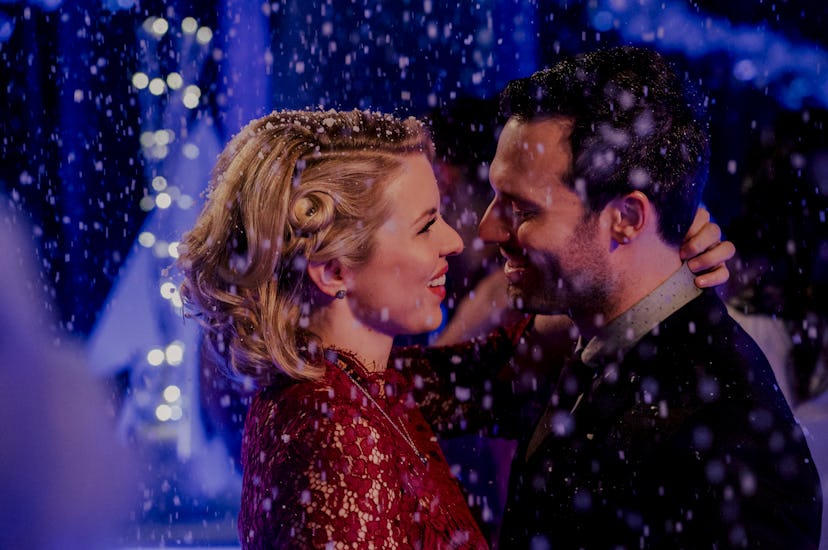 Ali Liebert and Jake Epstein dancing and smiling at each other in A Storybook Christmas