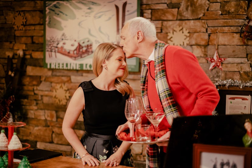 Melissa Joan Hart as Holly in Christmas Reservations with Michael Gross as Tom Anderson kissing her ...