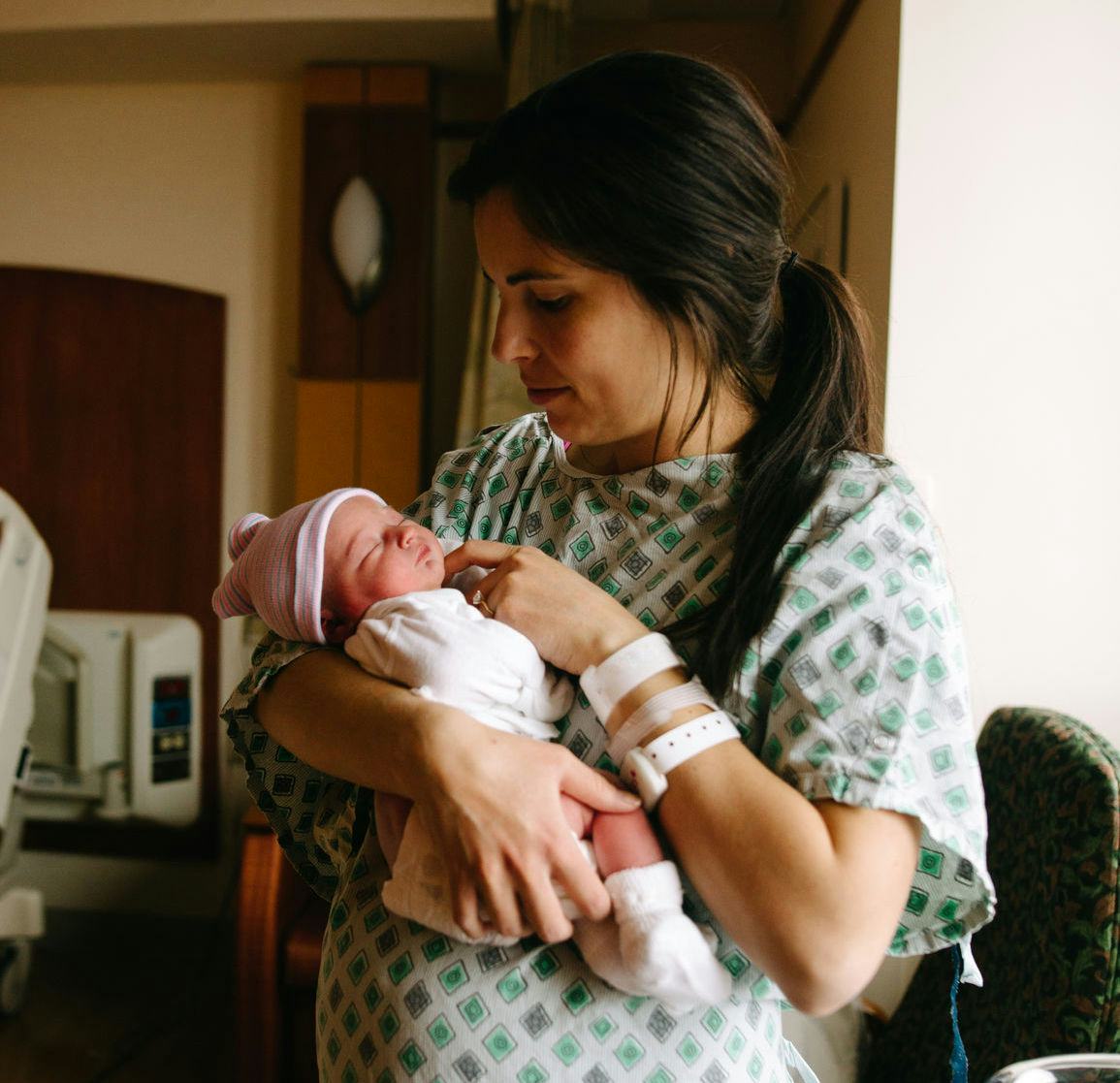 A mother holding her newborn baby in the hospital