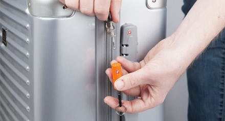 A man using the TravelMore Luggage Locks on a suitcase