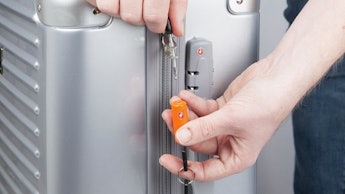 A man using the TravelMore Luggage Locks on a suitcase