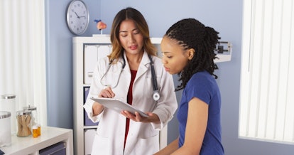 The patient reads her lab results shown by a doctor