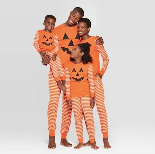 A family in Target's matching pumpkin Halloween pajamas