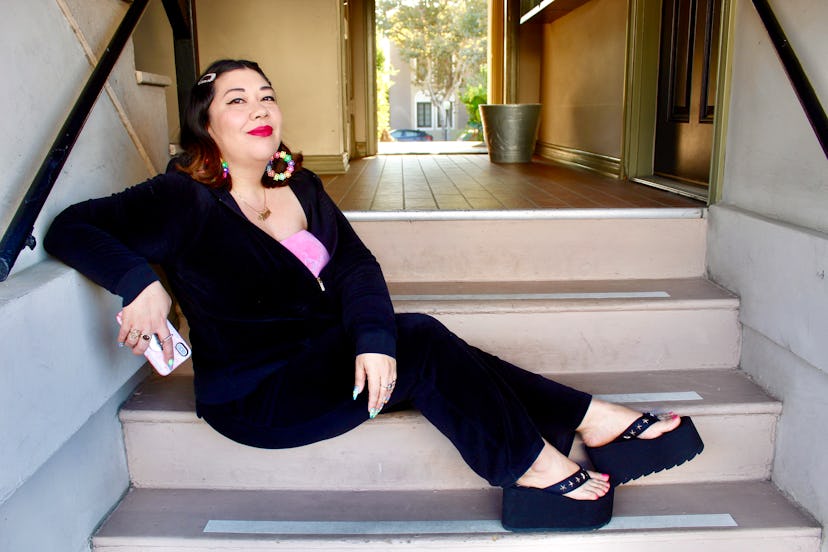 A middle-aged lady wearing black sandals with black platform