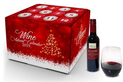 A 2019 wine and champagne advent calendar next to a bottle and glass of red wine 