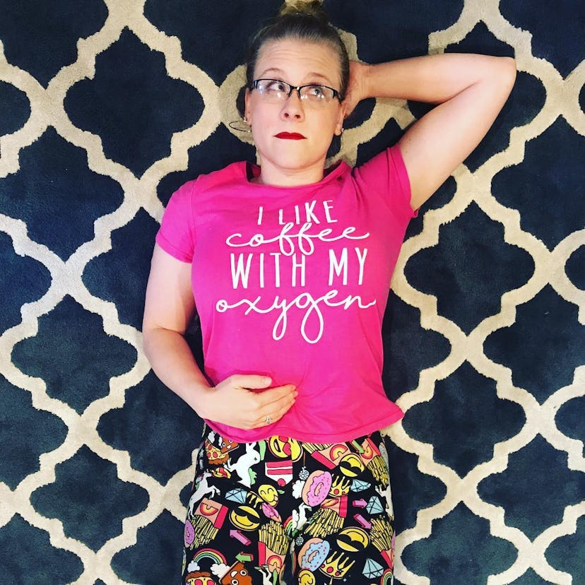 Crystal Henry posing on a tiled floor wearing a shirt that reads I like oxygen with my coffee