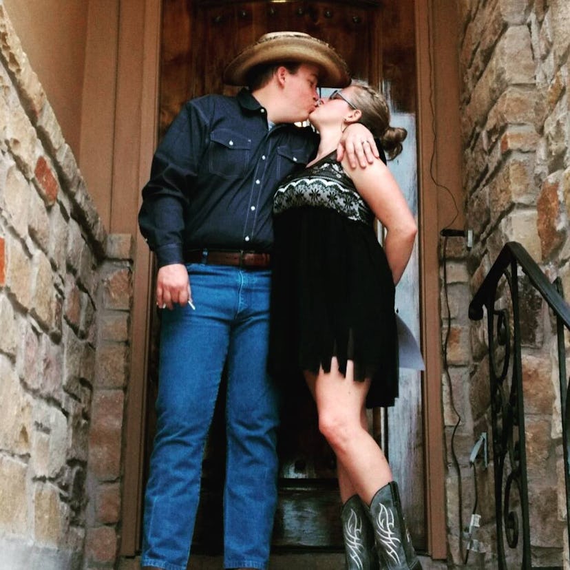 Crystal Henry and her husband standing and kissing on the stairwell of their house