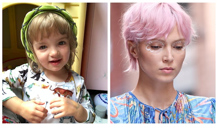 A girl wearing a green headband and a shirt with illustrated animals on it next to a woman with pink...