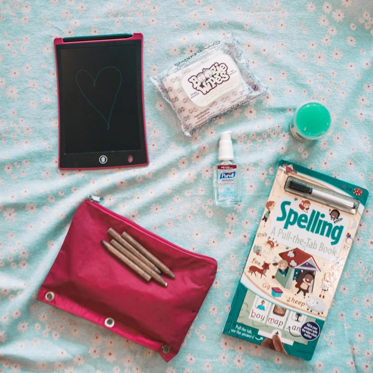 Flarp, coloring pencils, a book, sanitizer and wet wipes from a mom's bag