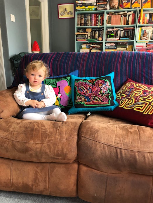 A little girl sitting on a couch