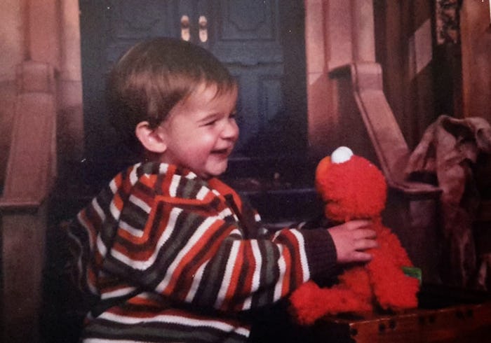 A little smiling son with an Elmo Doll before his death