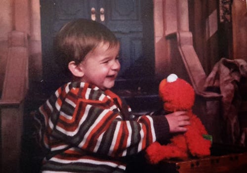 A little smiling son with an Elmo Doll before his death