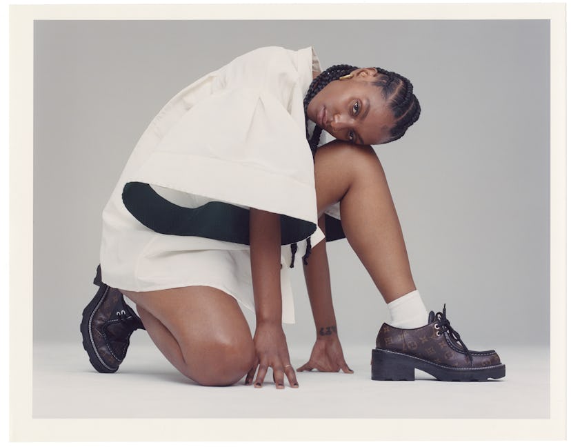 Mereba posing in a white Carolina Herrera shirt and Louis Vuitton shoes. 