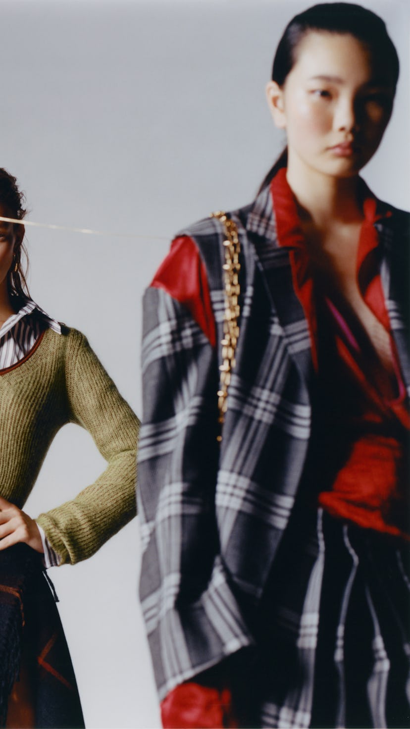 Two models wearing Salvatore Ferragamo knit sweater, shirt, skirt; Hannah Jewett earrings. Marni jac...