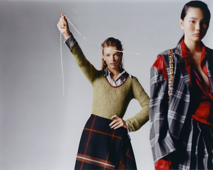 Two models wear Salvatore Ferragamo knit sweater, shirt, skirt; Hannah Jewett earrings. Marni jacket...