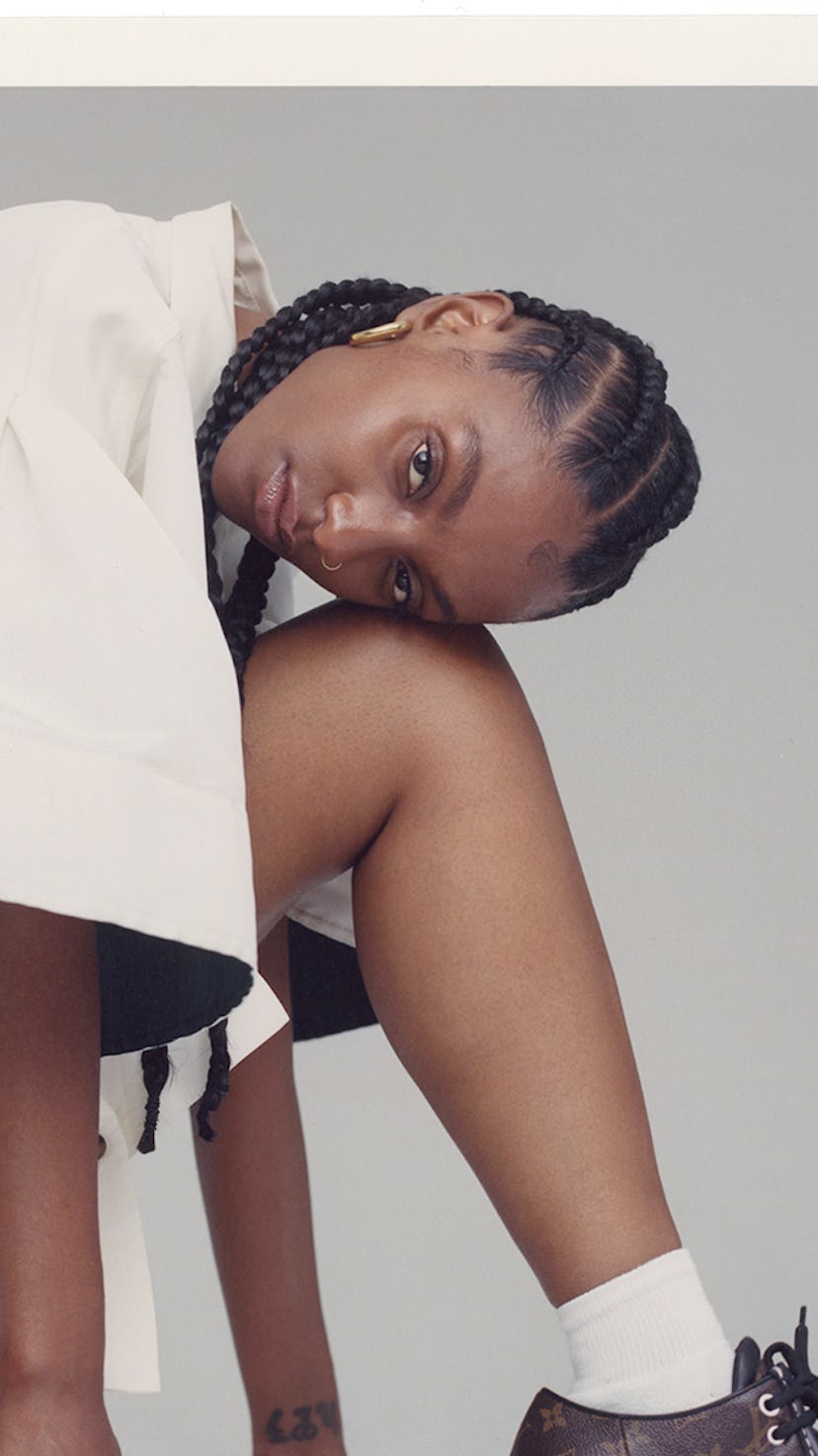 A model wearing menswear for women posing for a photo