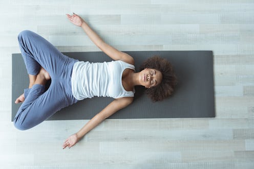 Woman doing after-work meditation at home