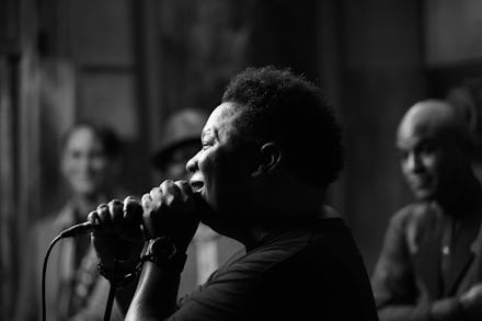 Black and white photo of Mannie Fresh singing