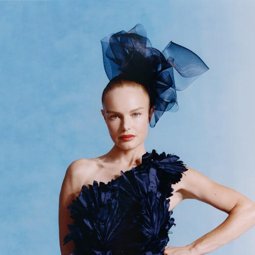 Kate Bosworth poses in the Oscar de la Renta dark blue gown and a matching headpiece.