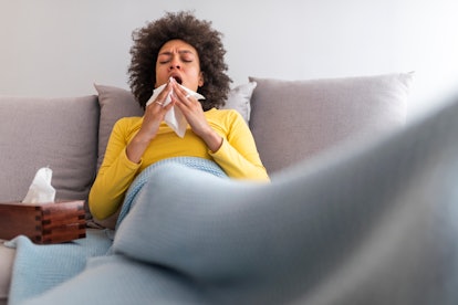 a woman is sneezing, sometimes a sign of early pregnancy