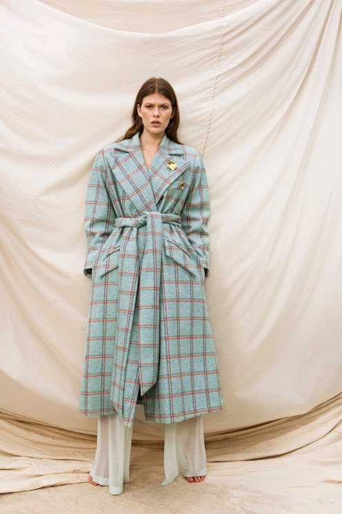 A model in a Here to Stay Coat by Maggie Marilyn and beige trousers