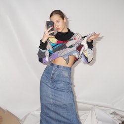 A model taking a mirror selfie while wearing ukranian fashion brands