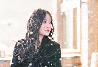 Young Asian woman walking in snow