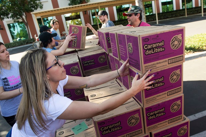 Volunteer Katie O'Neill, 29, of Orange, and several of her First American Title co-workers stack Car...