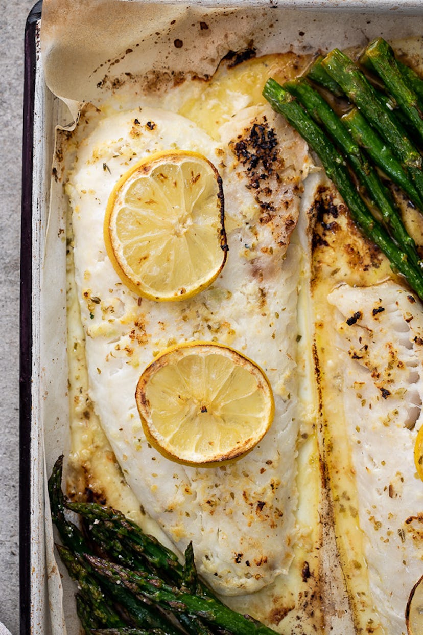 Close up of sheet pan lemon butter fish and asparagus