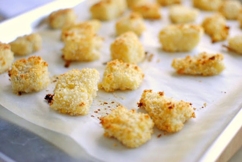 Crispy baked fish nuggets sheet pan close up