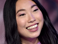 Awkwafina poses with her long, blunt-cut hair, one of the top long haircut trends of the year.