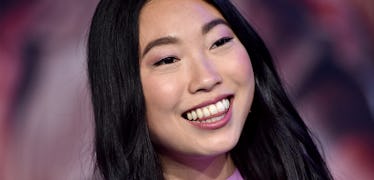 Awkwafina poses with her long, blunt-cut hair, one of the top long haircut trends of the year.