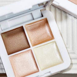 RMS Beauty's new Living Luminizer Glow Quad Mini featuring four highlighter and bronzer shades.