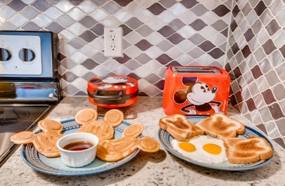 This Mickey Mouse-themed Airbnb has Mickey kitchen appliances with plates of Mickey-shaped pancakes ...