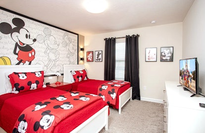 This Mickey Mouse-themed Airbnb has Mickey bed sheets in the bedroom. 