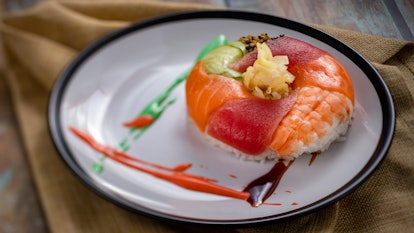 The donut-shaped sushi served at Epcot's International Festival of the Arts sits on a white plate. 