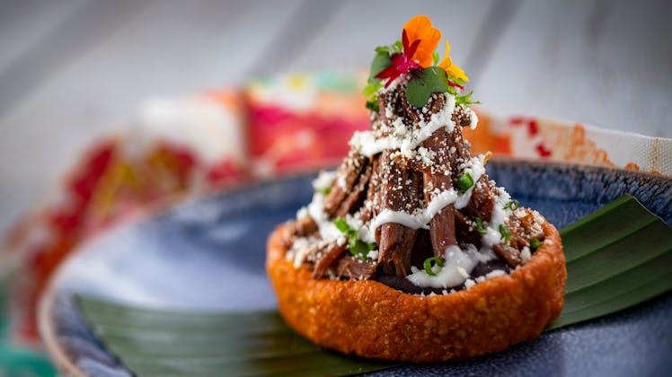 The barbecoa sopes served at Epcot's International Festival of the Arts sits on a plate.  