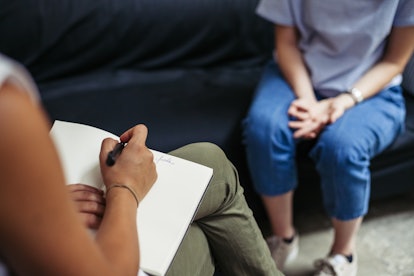 A woman sits in therapy. Making your mental health your top priority is a big wellness trend for 202...