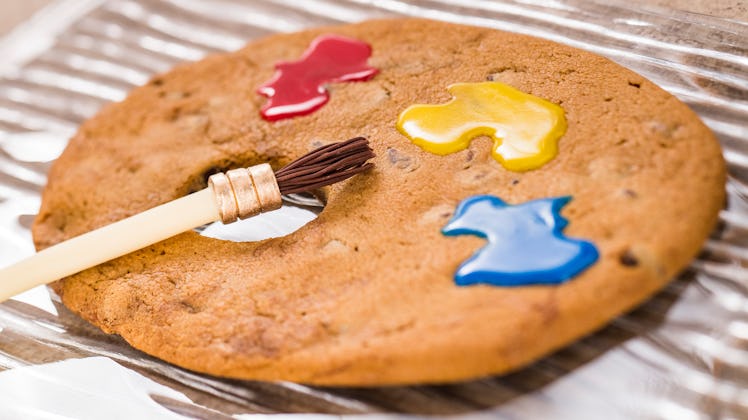 A paint brush sits on top of a artist palette-shaped cookie with colorful icing at Epcot's Internati...