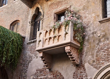 Juliet's balcony covered in pretty flowers overlooks Verona at the 'Romeo and Juliet'-inspired house...